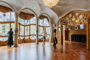 Guests with audio guides observing Casa Batlló artwork