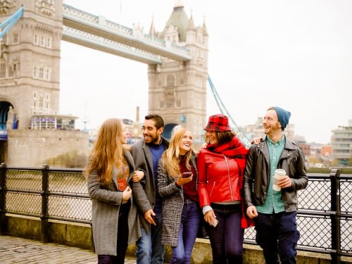 Friends smiling at Tower Bridge