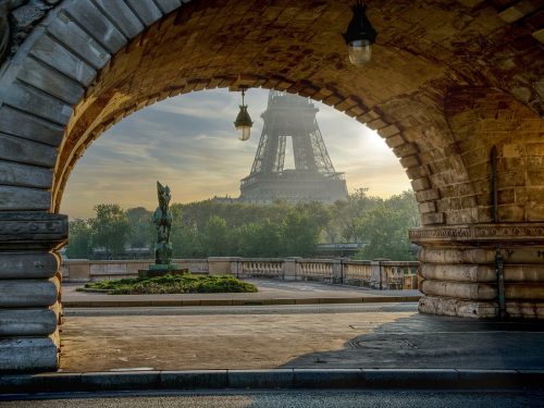 View of Eiffel Tower under arch alley way in Paris