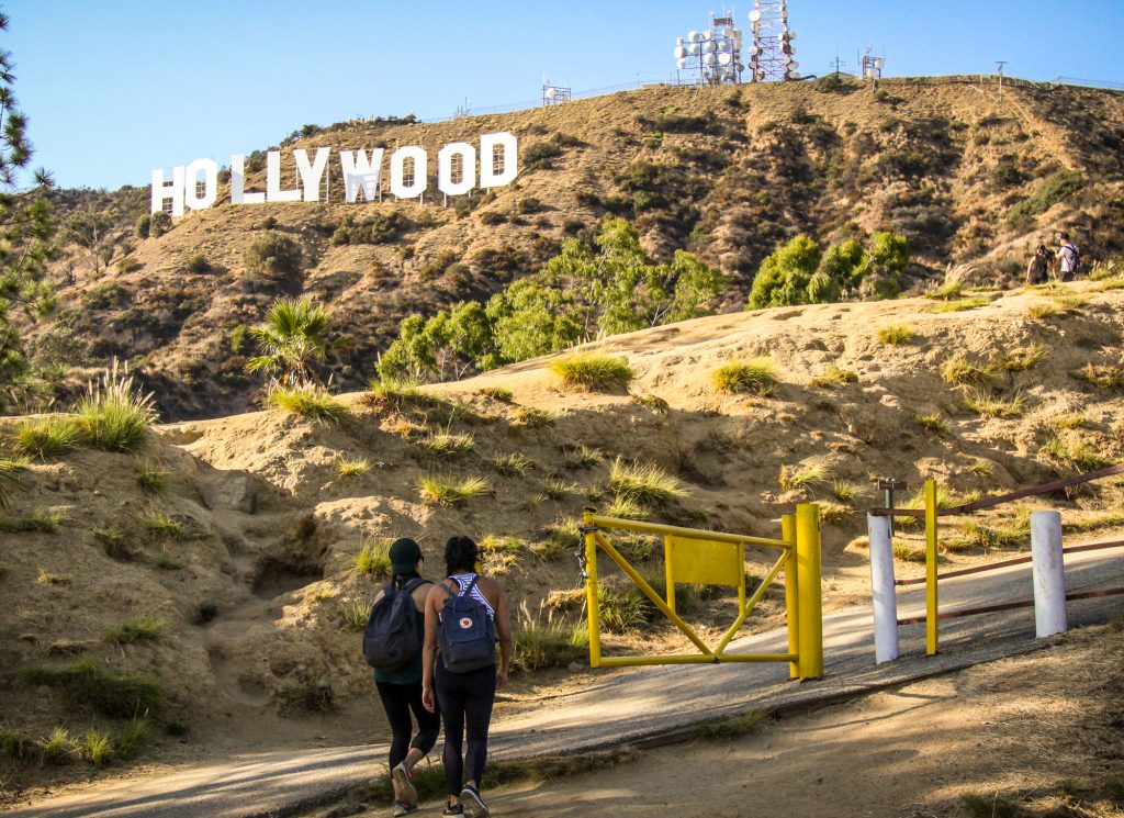 People walking with Hollywood Sign in the background