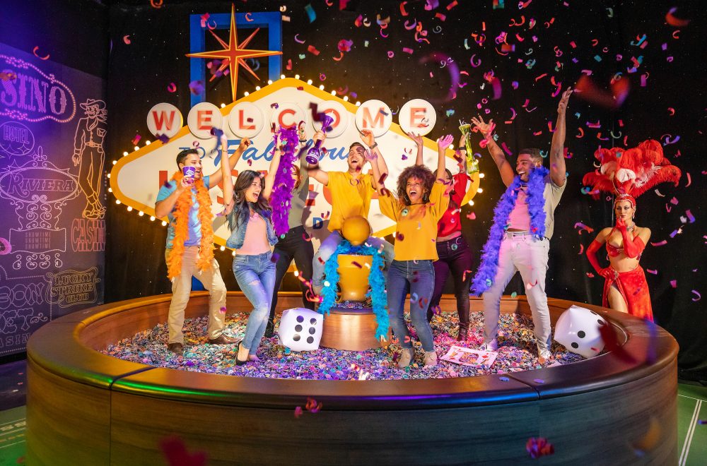 Group of people cheering and posing at the Las Vegas feature in Madame Tussauds Las Vegas