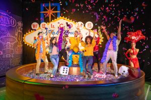 Group of people cheering and posing at the Las Vegas feature in Madame Tussauds Las Vegas