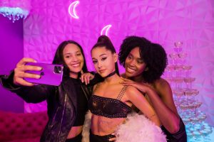 Two visitors taking a selfie with the Madame Tussauds Ariana Grande figure