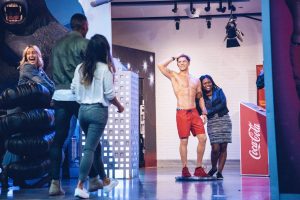 Visitors taking photo with Zac Efron Baywatch figure in Madame Tussauds