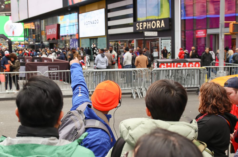 Tour Guide pointing in Times Square during Broadway Tour