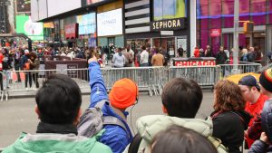 Tour Guide pointing in Times Square during Broadway Tour