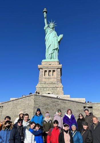 Statue of Liberty tour group photo in front of the statue