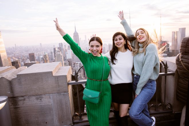 Three women posing at Top of the Rock in New York