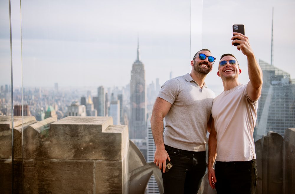 Two men taking a selfie at Top of the Rock in Rockefeller Center in New York