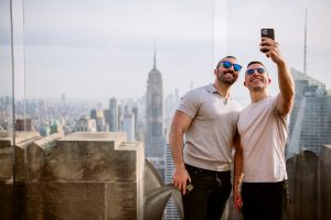 Two men taking a selfie at Top of the Rock in Rockefeller Center in New York