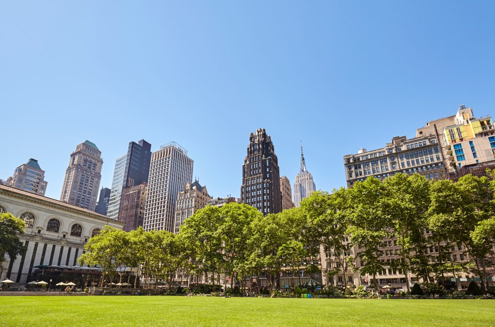 New York City skyline on a sunny summer day seen from the Bryant Park, USA.