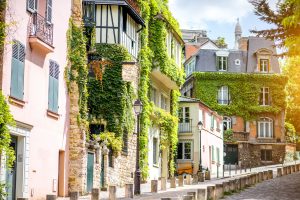 Cityscape view on the beautiful street with green buildings on Monmartre hill in Paris