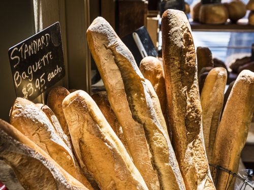 Baguettes in early morning sunlight by a windowsill in Paris