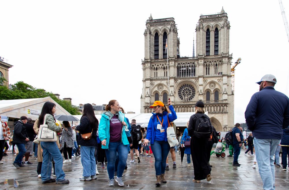 Tour Guide interacting with guest with Notre Dame in the background