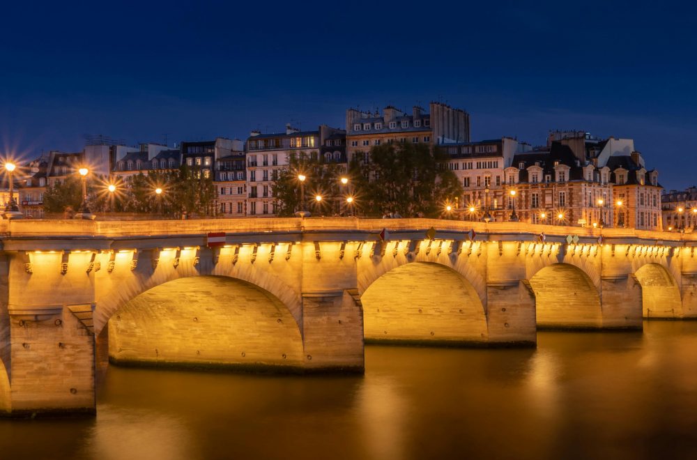 Pont Neuf Bridge Near Apartment Buildings Under Night Sky in Paris Ghost Tour