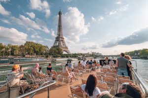 People on Seine River Cruise looking at the Eiffel Tower in Paris