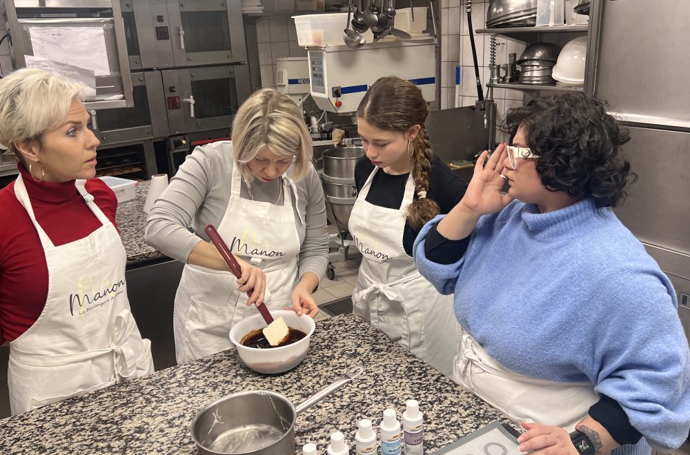 Guest mixing chocolate ganache during Paris macaron baking class