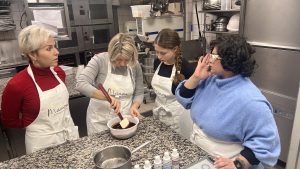 Guest mixing chocolate ganache during Paris macaron baking class