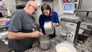 Guests pouring ingredients into bowl