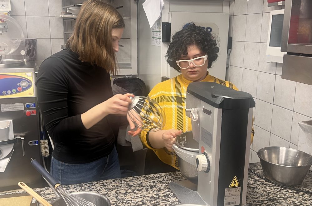 Guests setting up automatic mixer during Paris macaron baking class