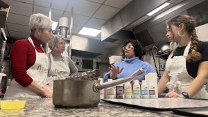 Guide talking to guests in Paris macaron baking class