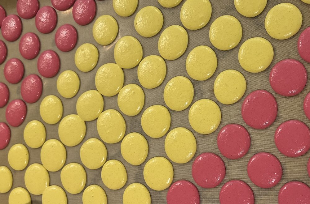 Tray of yellow and pink macarons