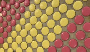 Tray of yellow and pink macarons