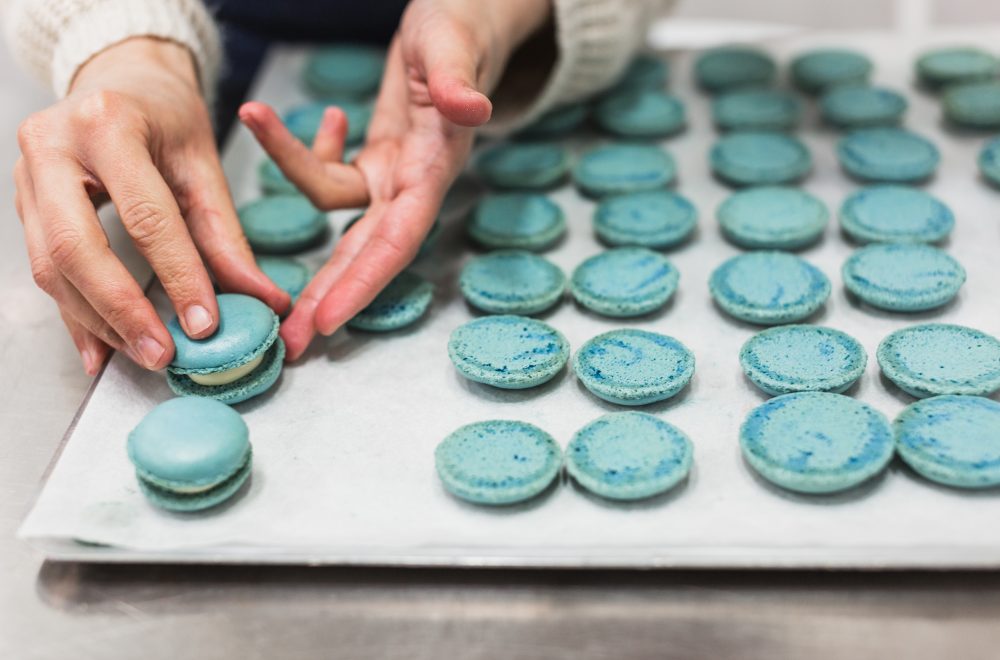 Woman assembling macarons during Macaron Baking Class in Paris