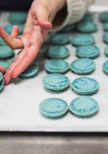 Woman assembling macarons during Macaron Baking Class in Paris