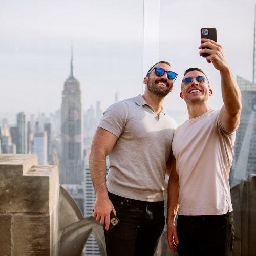 Two men taking a selfie at Top of the Rock in Rockefeller Center in New York