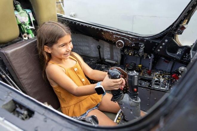 Girl playing inside an exhibit at the USS Midway Museum