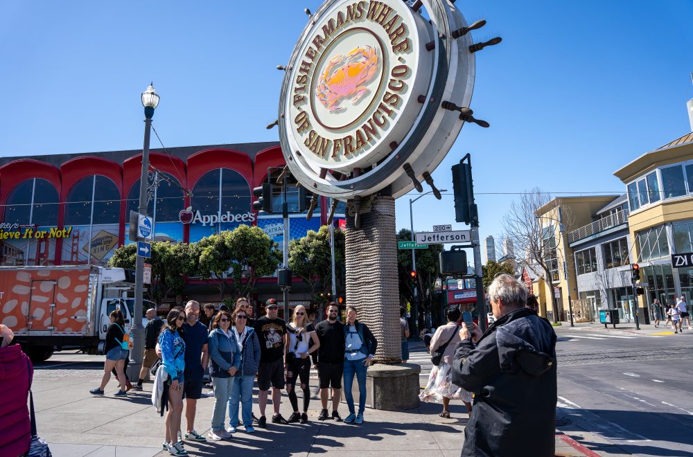 Guide taking group photo during Fisherman_s wharf tour